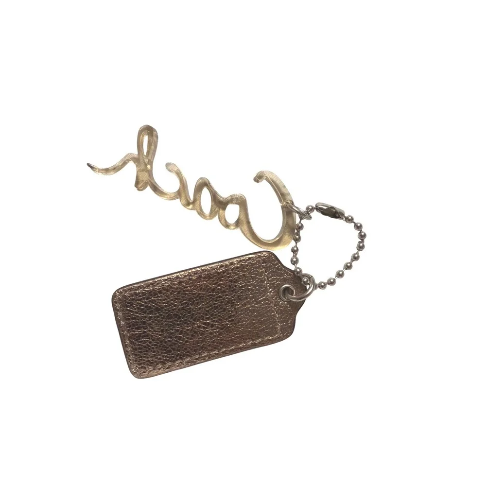 Coach Metallic Bronze Leather Hangtag and Clear Acrylic Script Logo Bag Charm